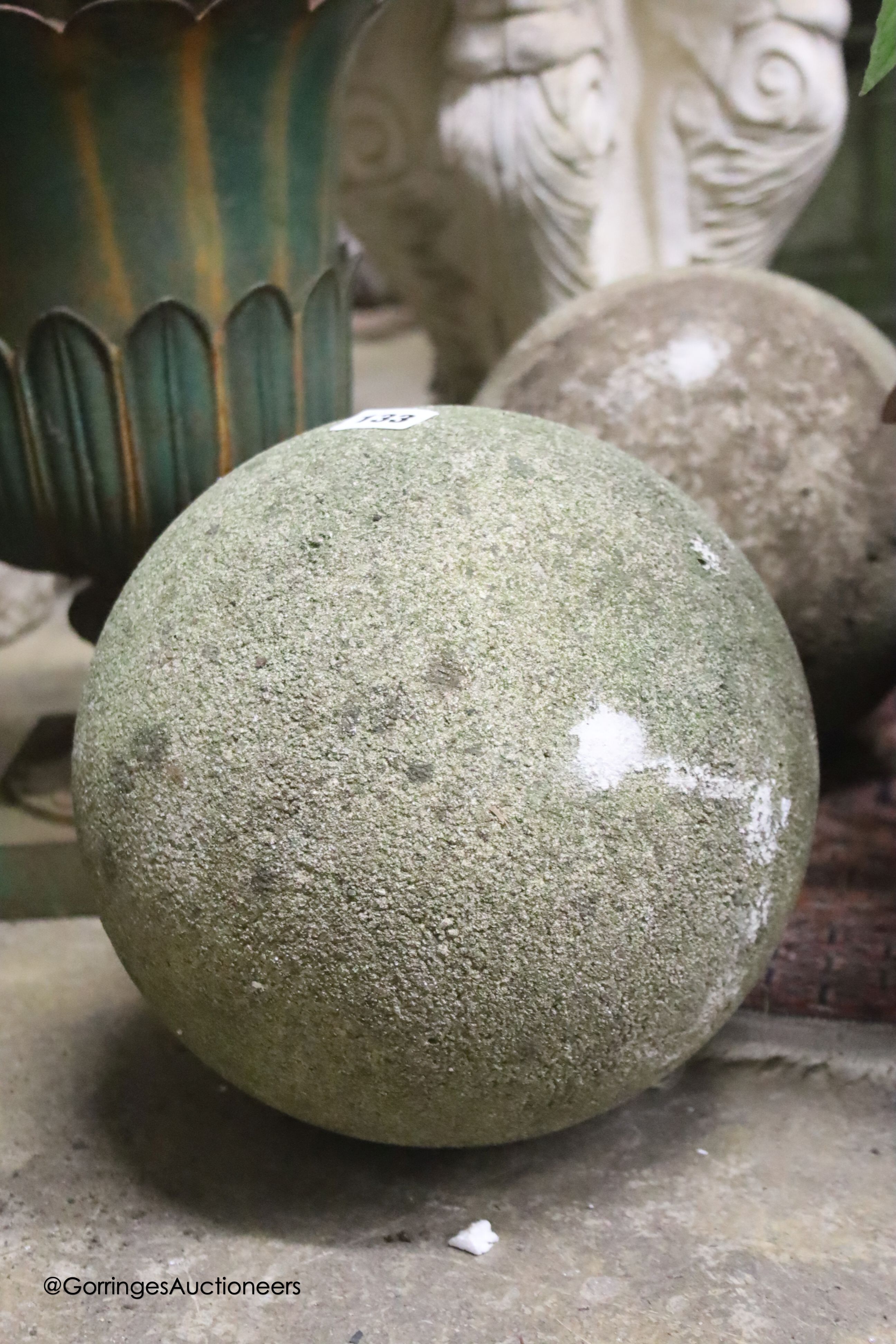 A pair of reconstituted stone spherical garden ornaments, height 24cm